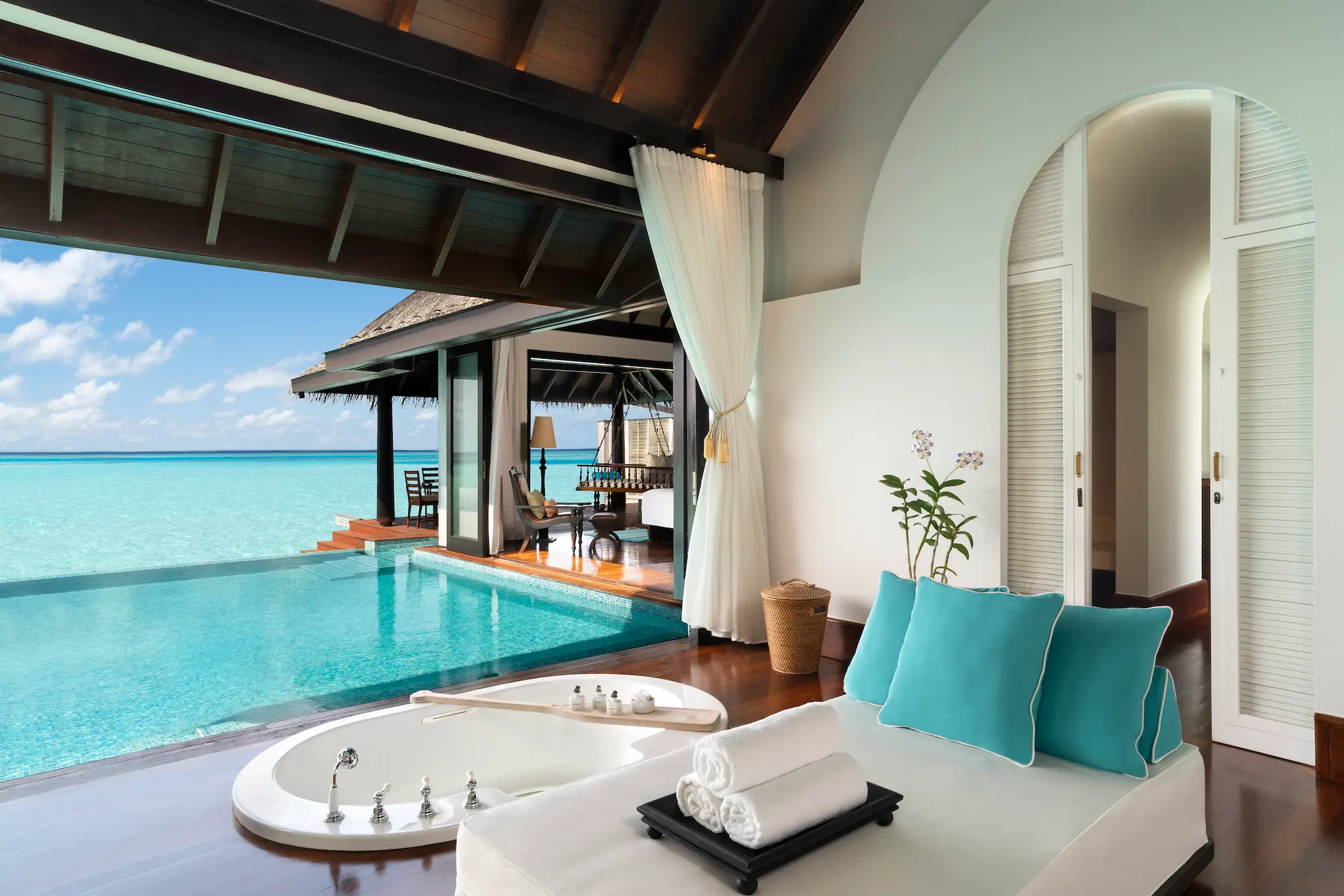 serene overwater villa bathroom at anantara kihavah maldives villas featuring a tranquil pool and ocean horizon