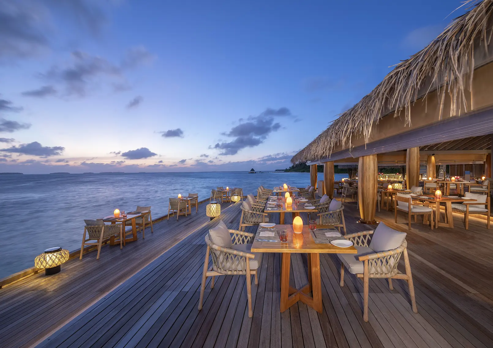 open deck area of spice restaurant at anantara kihavah maldives villas offering relaxed island dining by the water