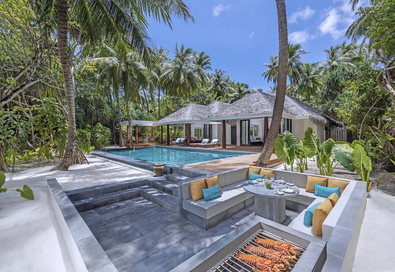 outdoor bbq terrace of the two bedroom family beach pool villa at anantara kihavah maldives villas offering a relaxed beachfront dining setting