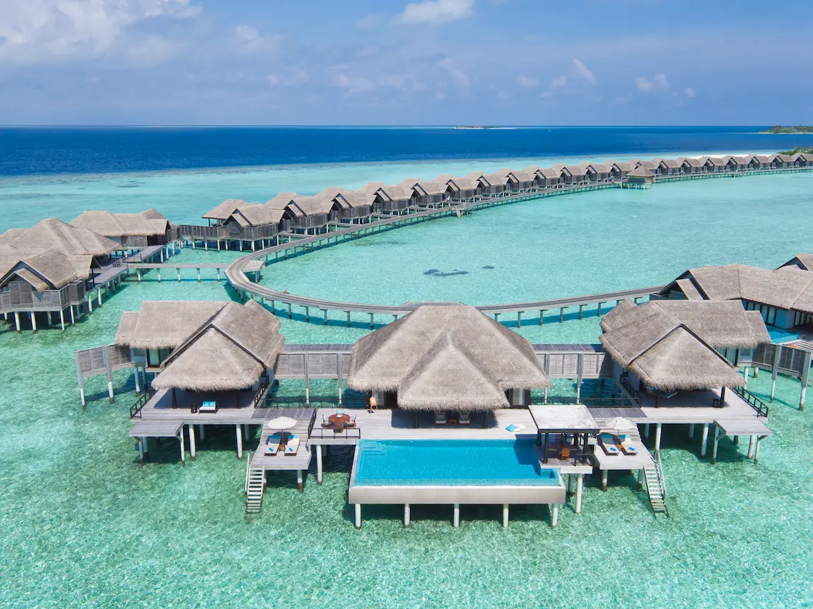 exterior view of anantara kihavah maldives villas surrounded by turquoise lagoon and tropical serenity