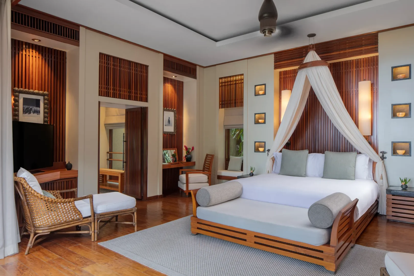 bedroom in a beach pool villa at Anantara Maia Seychelles Villas featuring a large bed with views of the private pool, tropical garden, and nearby ocean