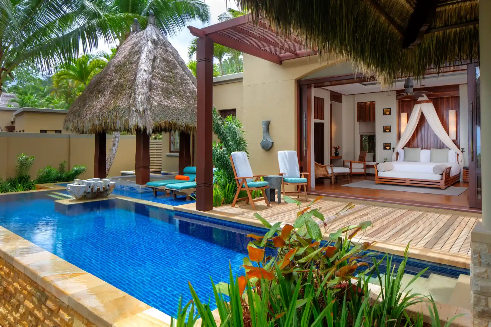 private pool of a beach pool villa at Anantara Maia Seychelles Villas surrounded by tropical garden with direct proximity to the beachfront and ocean views