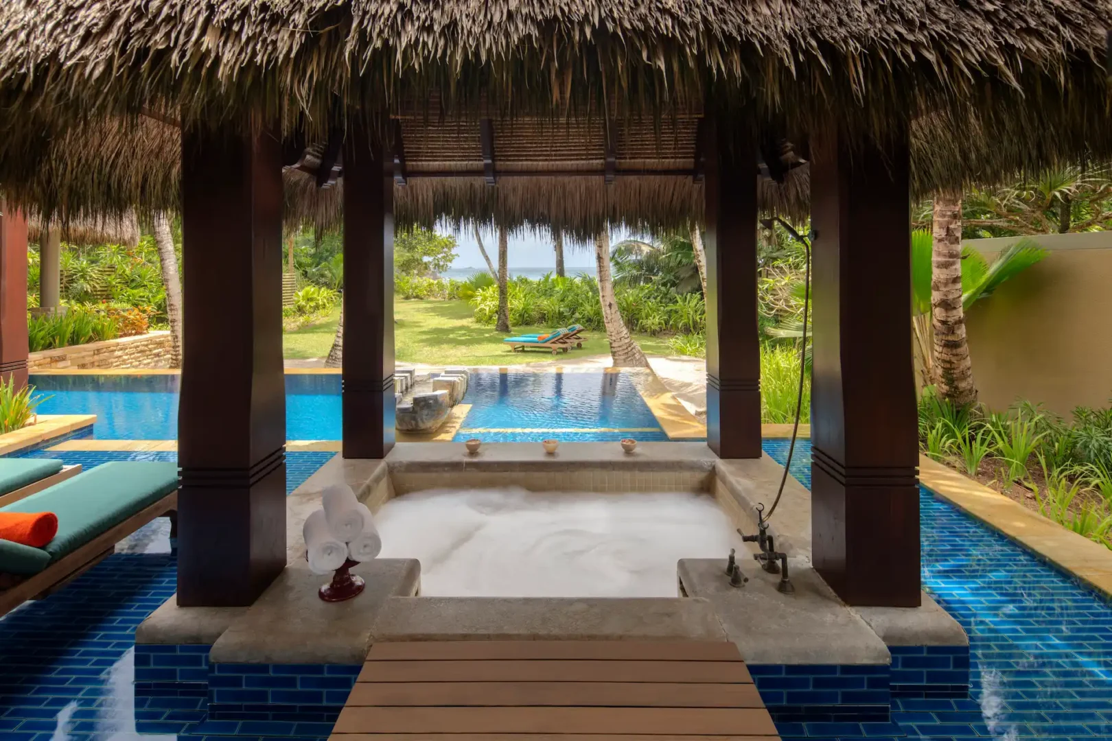 "sunken bath in a beach pool villa at Anantara Maia Seychelles Villas set in a private outdoor space surrounded by tropical garden and near the beachfront with ocean views