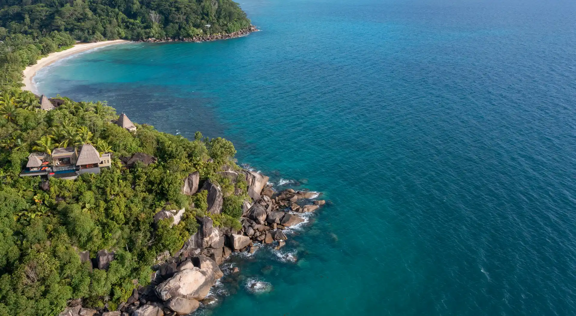 exterior view of villas at Anantara Maia Seychelles Villas set among lush tropical forest with ocean views and natural surroundings