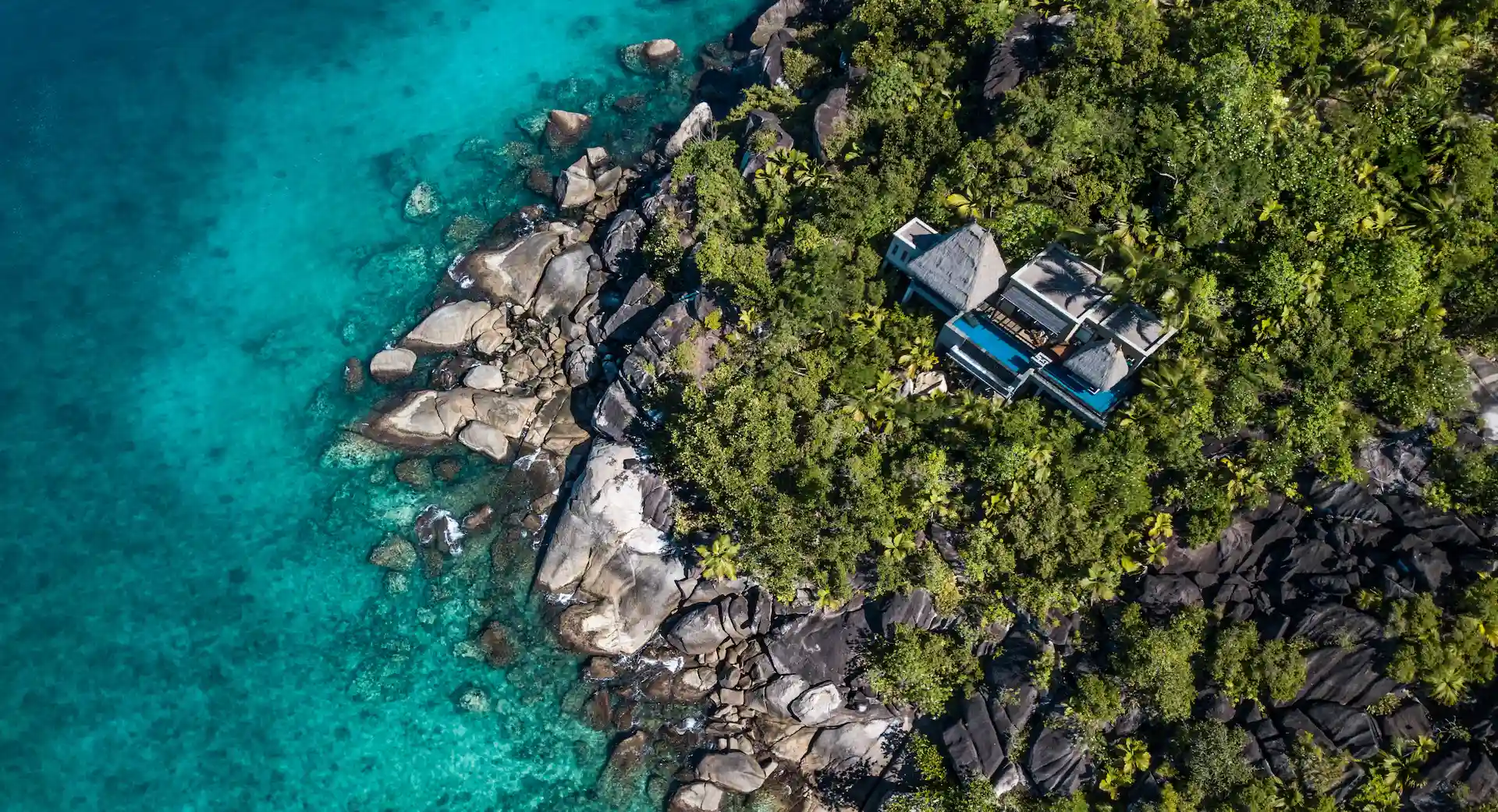 aerial view of an ocean view pool villa at Anantara Maia Seychelles Villas set among tropical forest with a private pool overlooking the ocean coastline