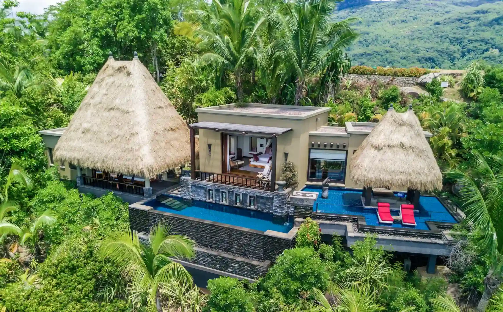 exterior of an ocean view pool villa at Anantara Maia Seychelles Villas surrounded by lush tropical greenery with a private pool and ocean views
