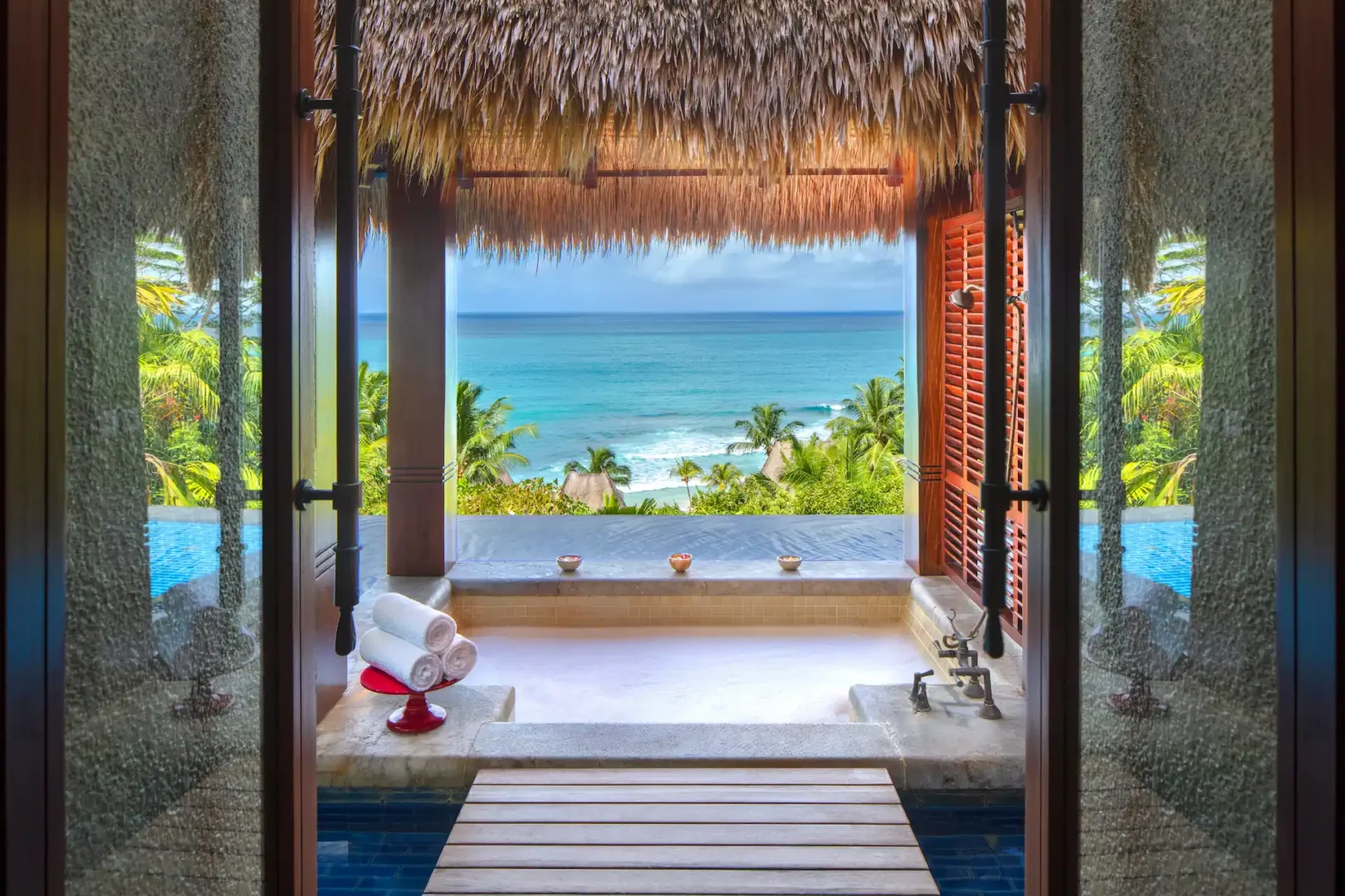 sunken bath in an ocean view pool villa at Anantara Maia Seychelles Villas with a private outdoor setting overlooking tropical greenery and the ocean