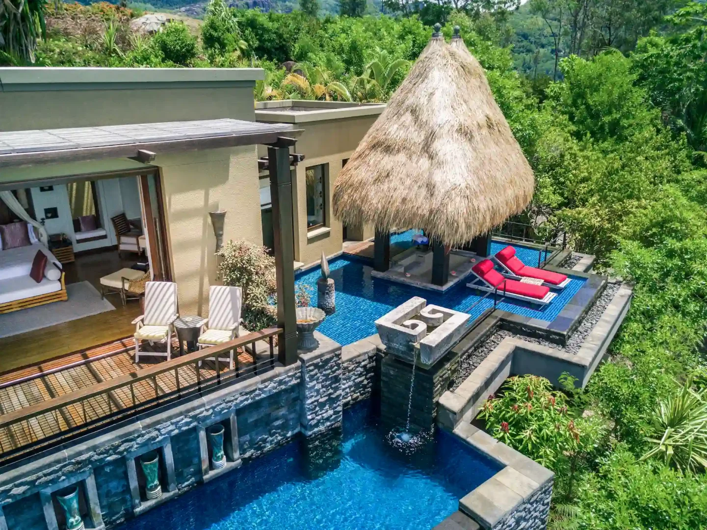 exterior of a premier ocean view pool villa at Anantara Maia Seychelles Villas surrounded by lush tropical forest with a private pool and ocean views