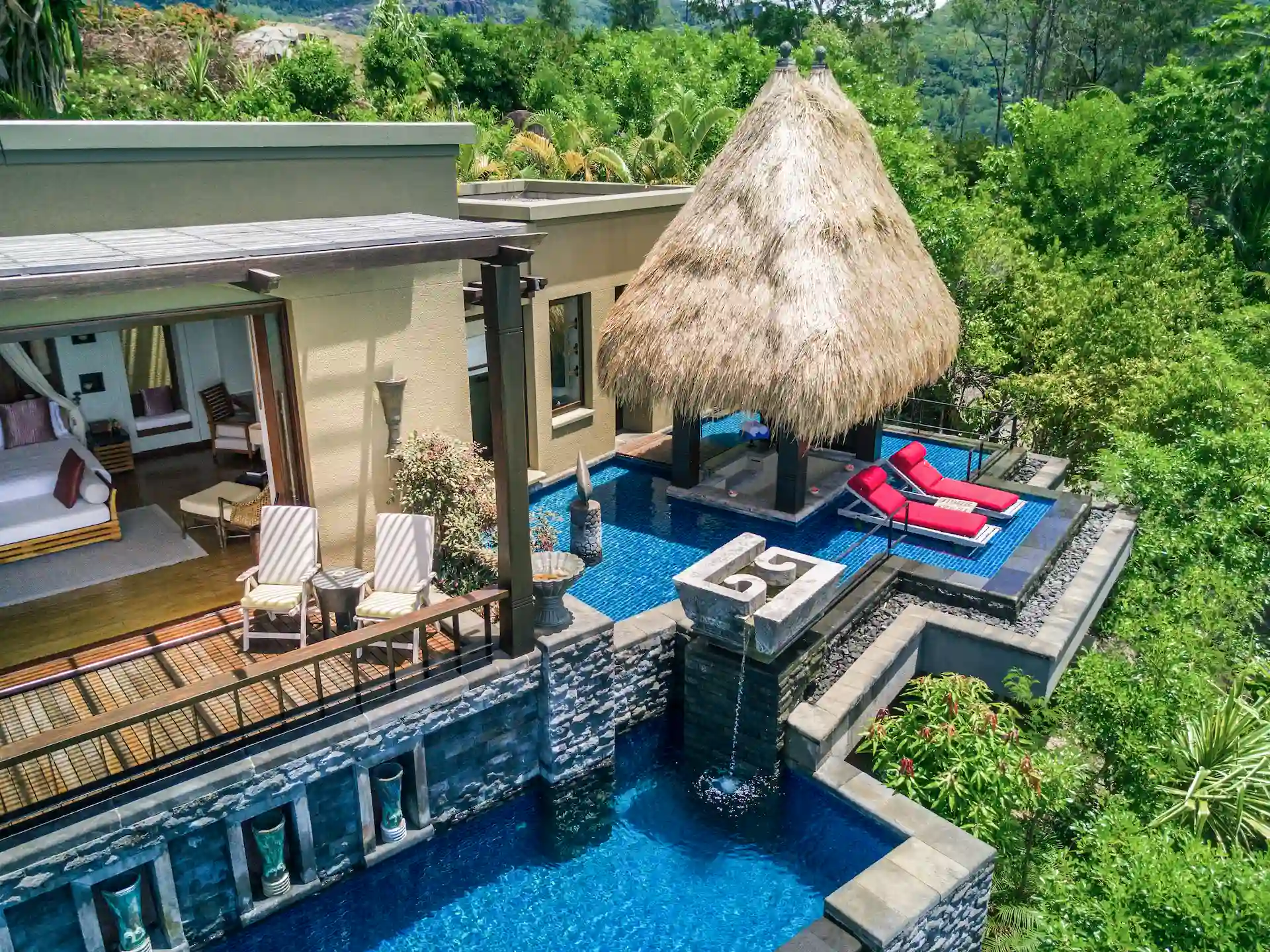 exterior of a premier ocean view pool villa at Anantara Maia Seychelles Villas surrounded by lush tropical forest with a private pool and ocean views