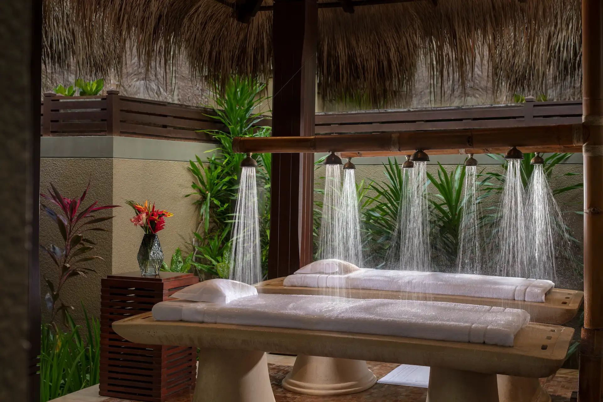 vichy shower spa treatment at Anantara Maia Seychelles Villas with multiple water jets over a treatment bed in a serene spa environment