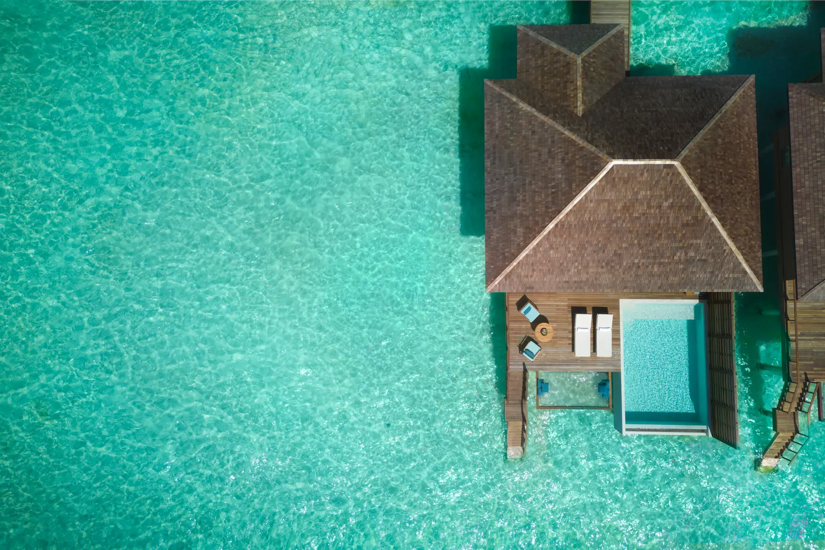 aerial view of the deluxe overwater pool villa at anantara veli maldives resort surrounded by clear turquoise lagoon waters