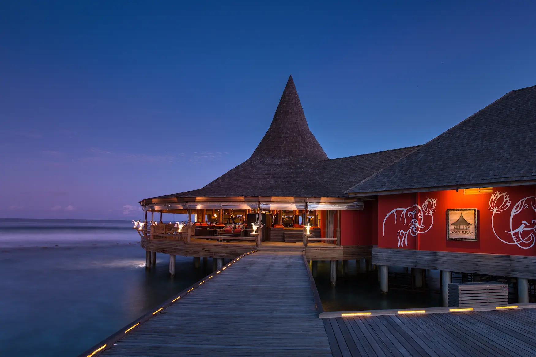 entrance to baan huraa restaurant at anantara veli maldives resort set above the lagoon with warm island charm