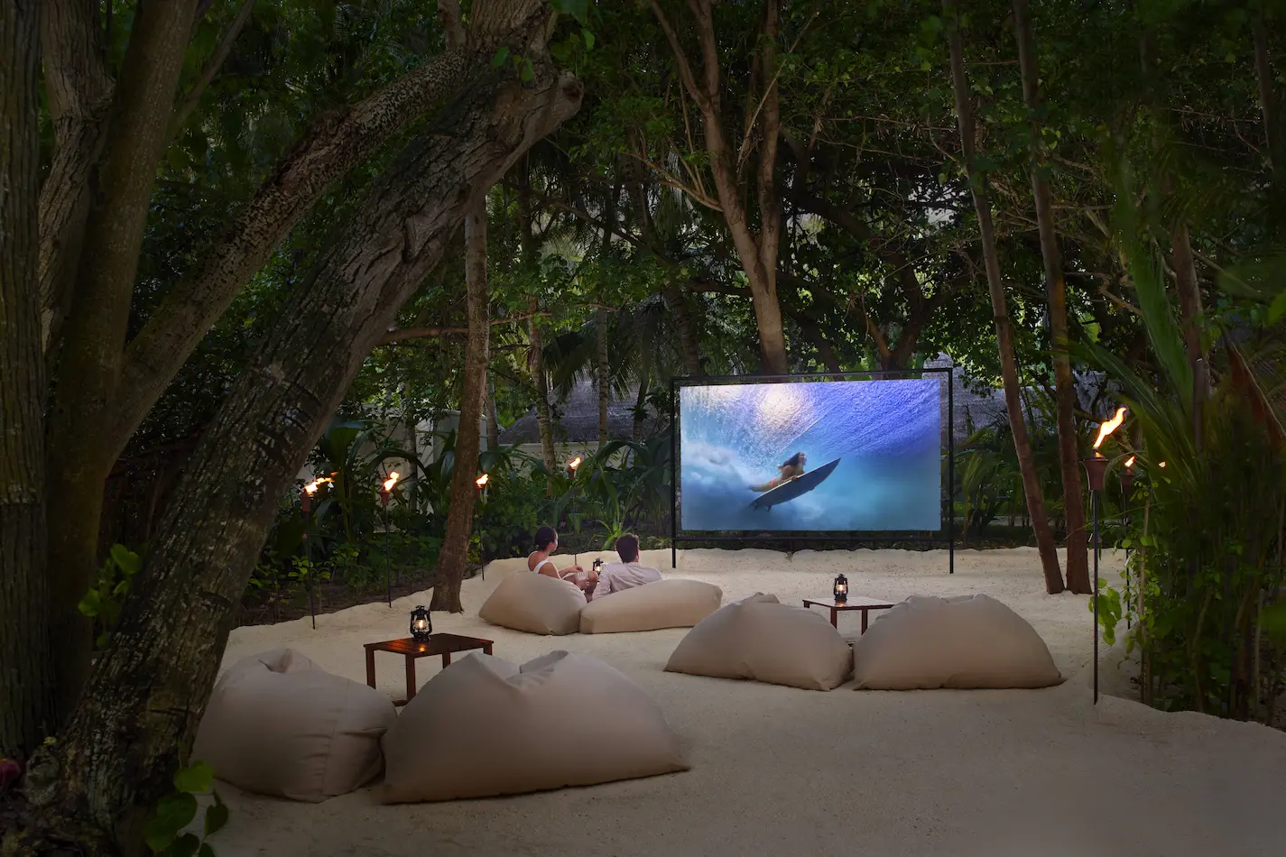 cinema under the stars experience at anantara veli maldives resort featuring a cosy beachfront setup beneath the night sky
