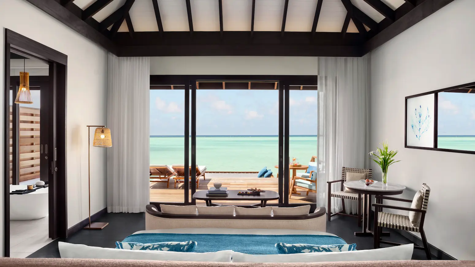 deluxe overwater pool villa bedroom at anantara veli maldives resort featuring calm lagoon views and elegant island serenity
