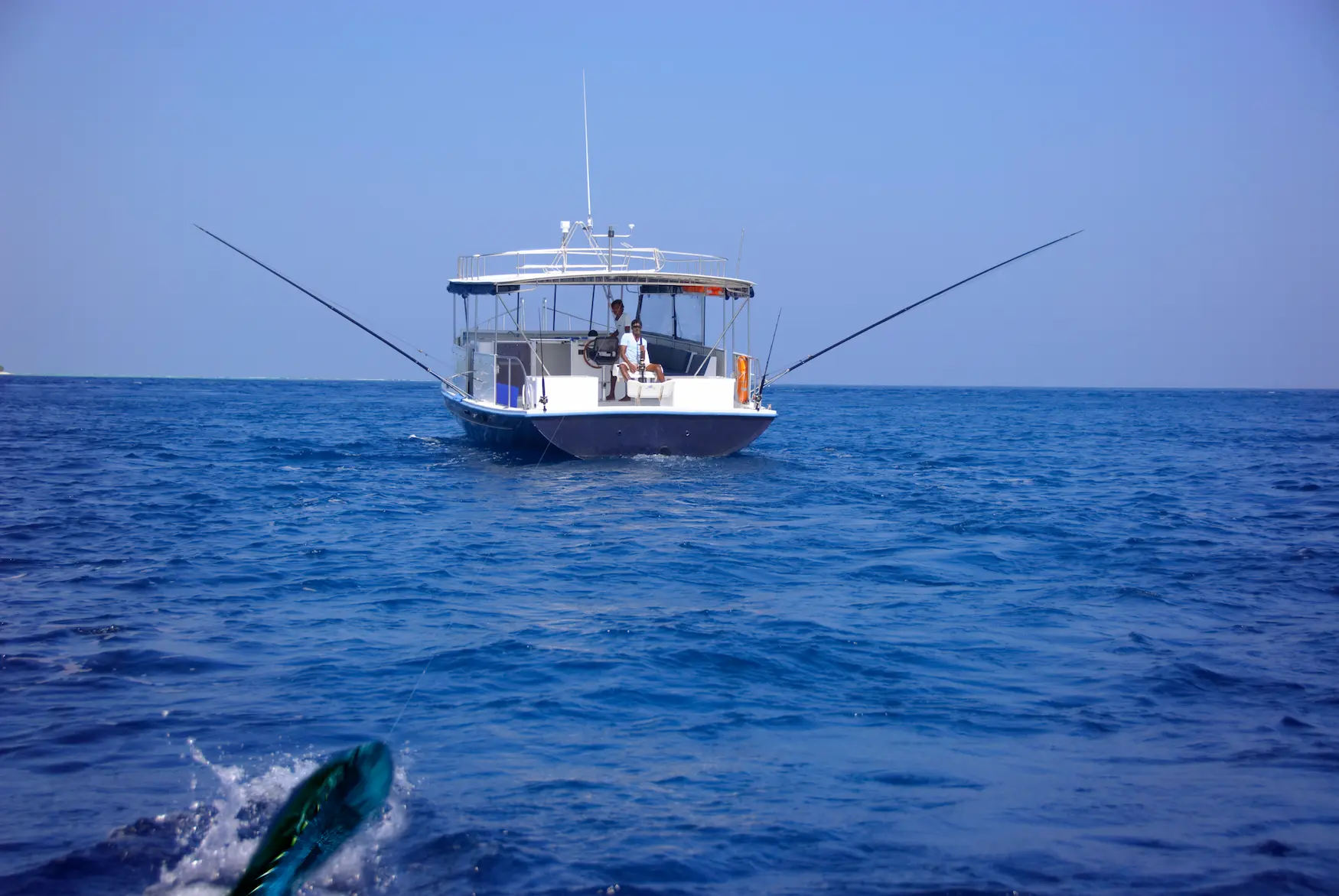 guest enjoying a tranquil fishing experience at anantara veli maldives resort surrounded by calm turquoise waters