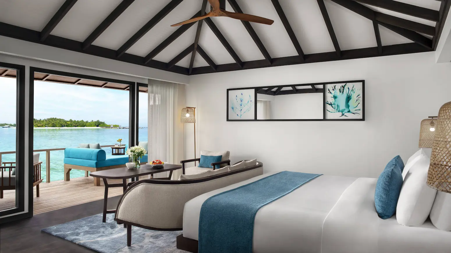 superior overwater villa bedroom views at anantara veli maldives resort showcasing tranquil turquoise lagoon scenery