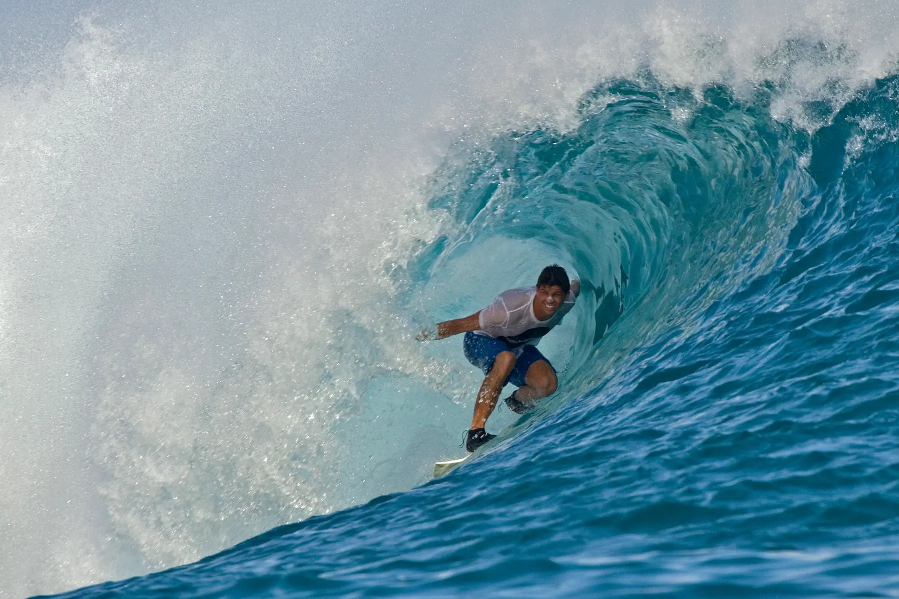guest surfing in the clear blue waters near anantara veli maldives resort enjoying an energising island adventure