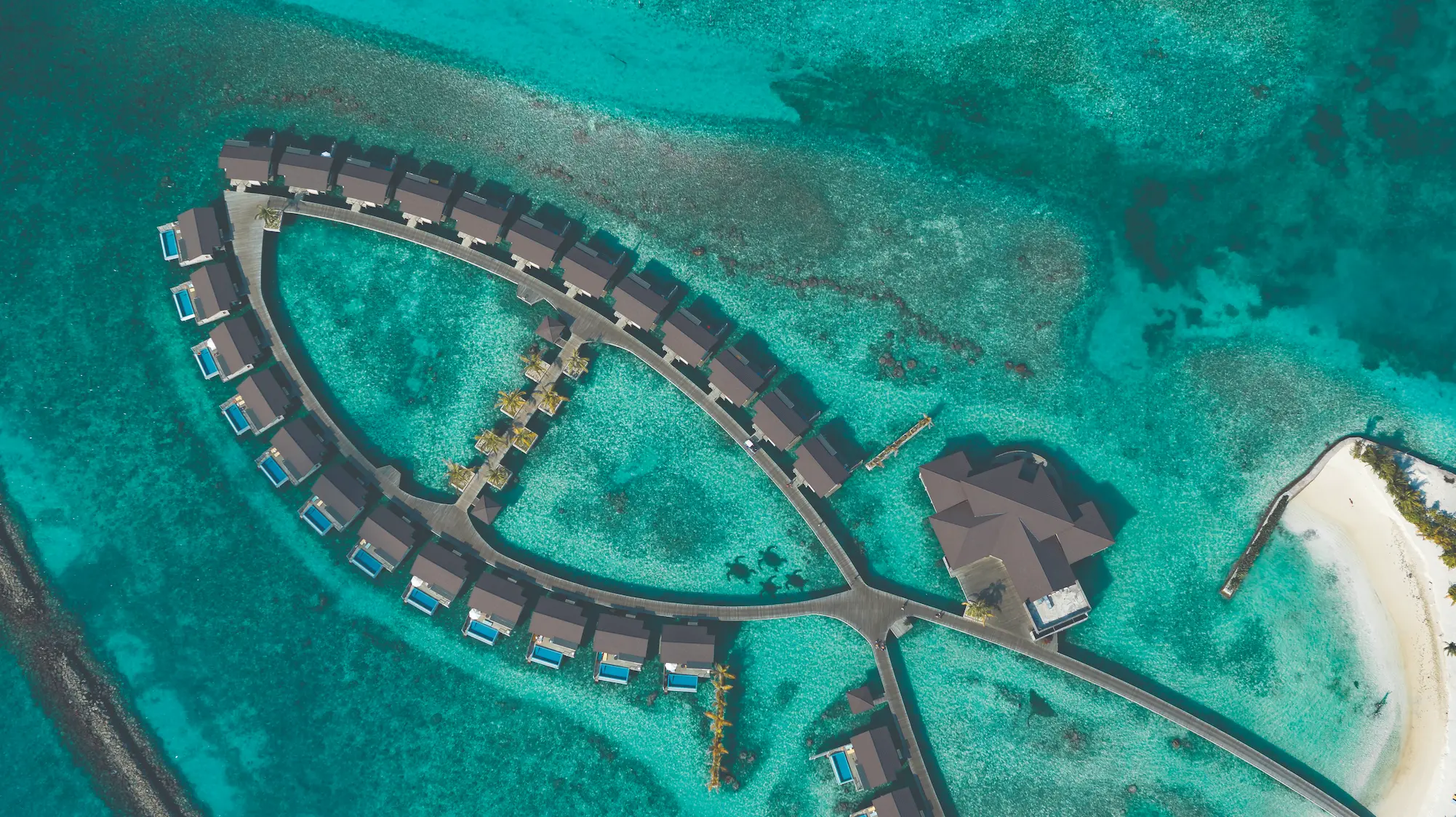 aerial view of the water villas stretching over the lagoon at atmosphere kanifushi