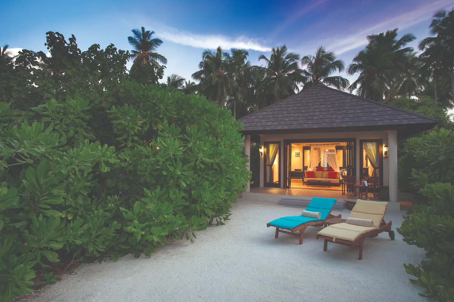 inviting sunset beach villa exterior perspective leading indoors atmosphere kanifushi maldives