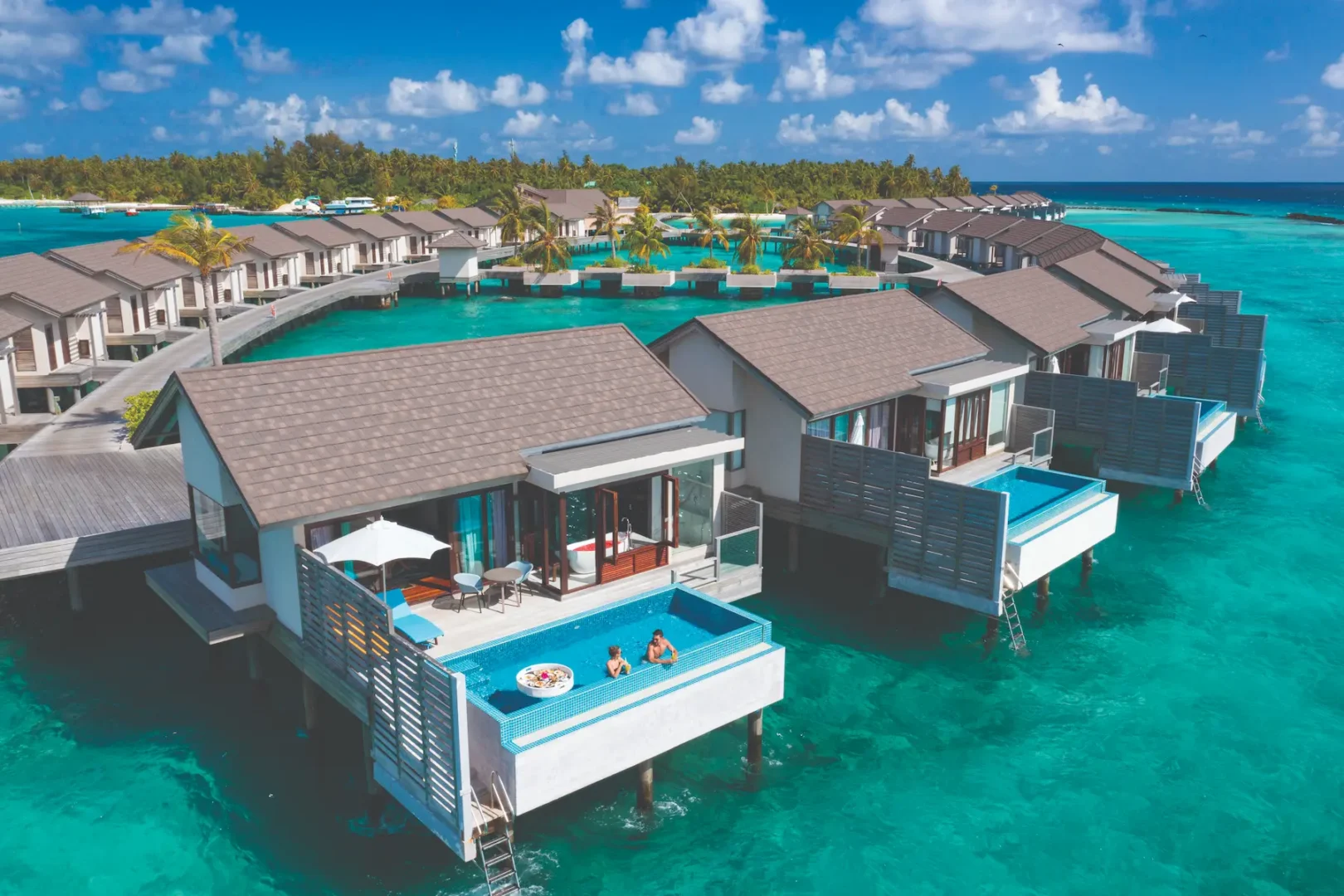 elevated aerial view of sunset water villa with private pool atmosphere kanifushi maldives