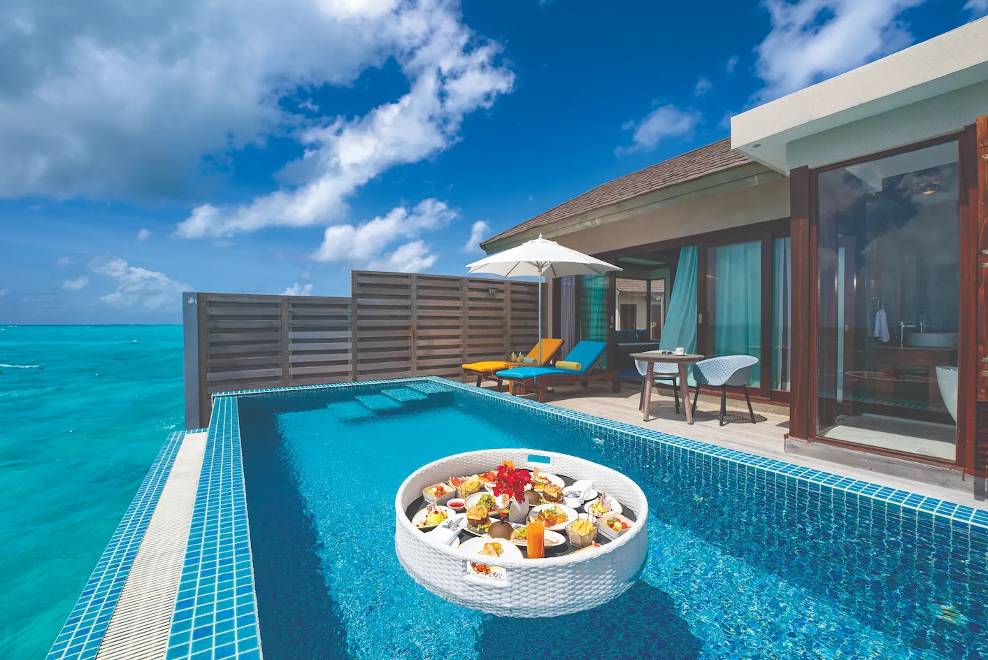 luxury floating breakfast served by sunset water villa with private pool atmosphere kanifushi maldives