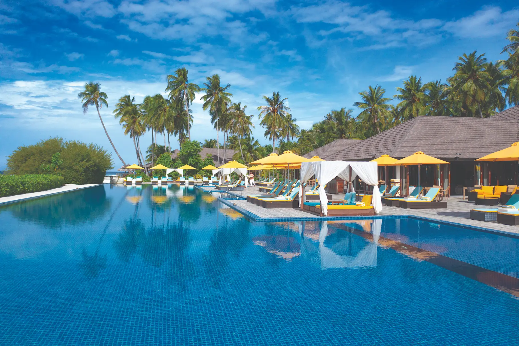 relaxed lifestyle moment by the liquid pool at atmosphere kanifushi maldives