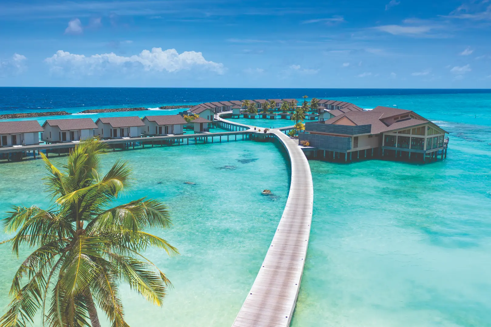 scenic water villa jetty stretching over turquoise lagoon atmosphere kanifushi maldives