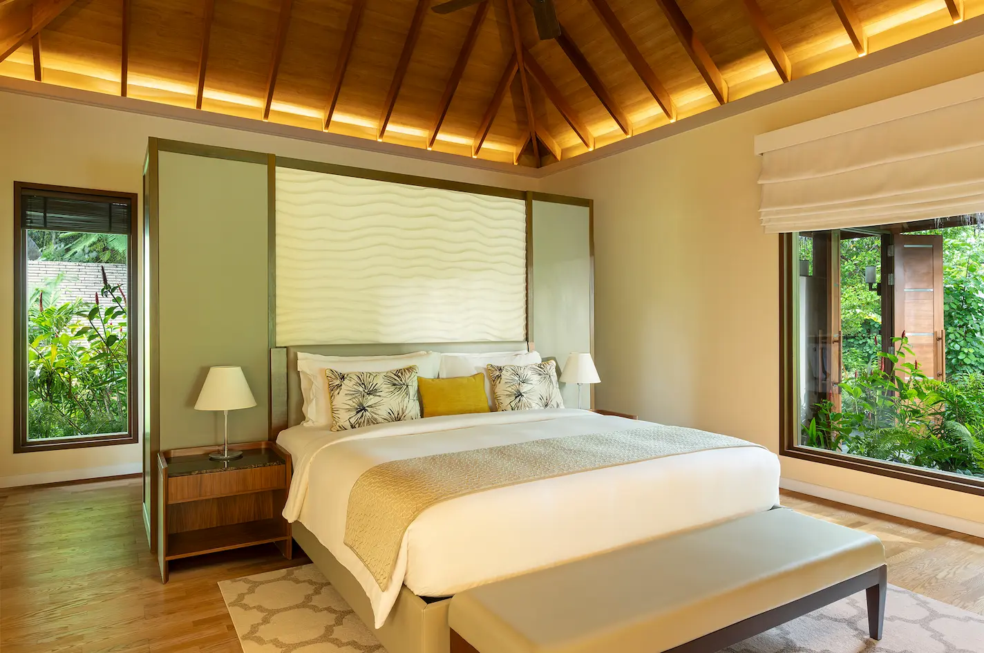 bedroom of the baros residence at baros maldives with elegant island design and warm natural light