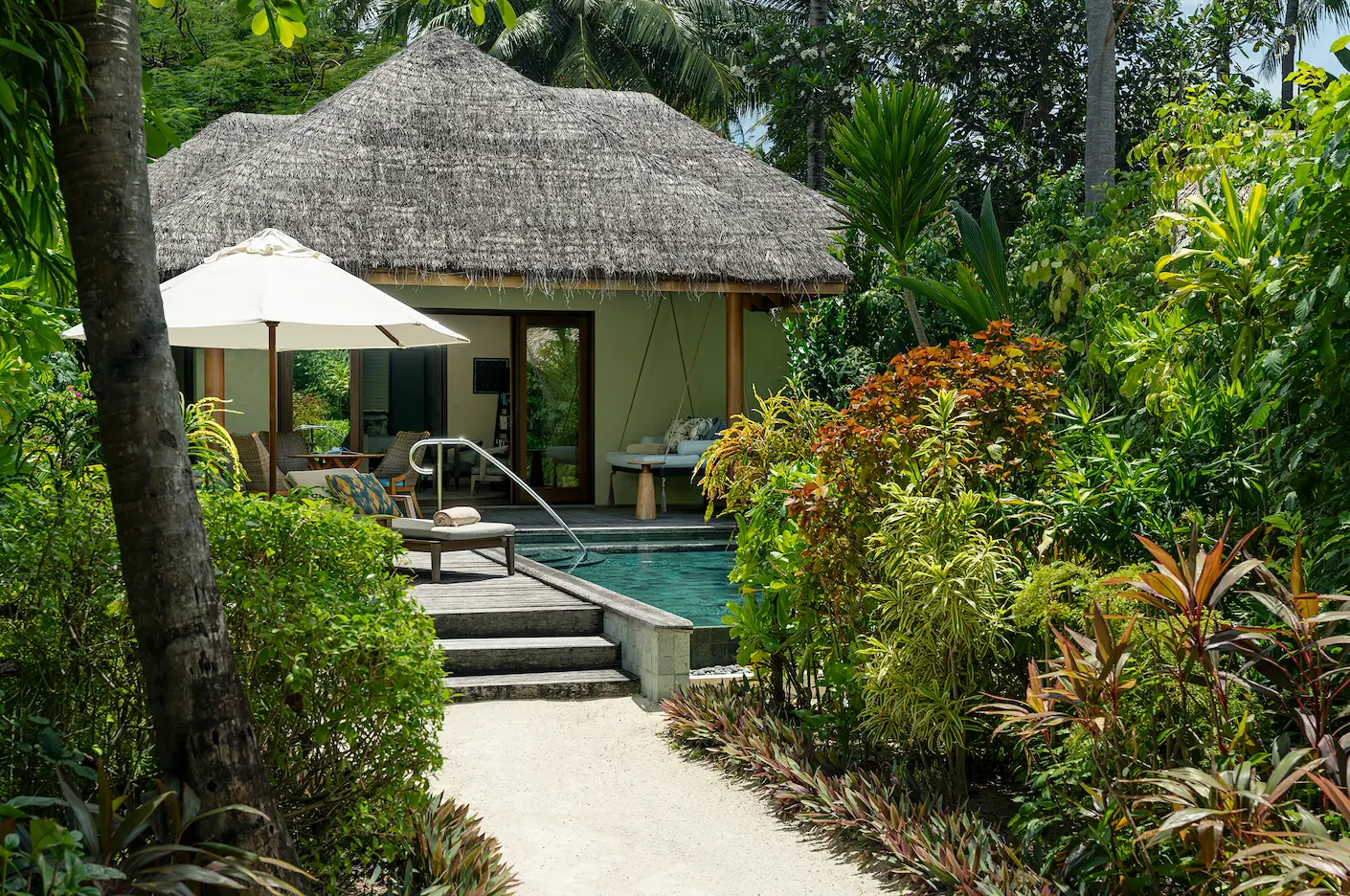 looking back toward the baros residence room at baros maldives with elegant island design and warm natural tones