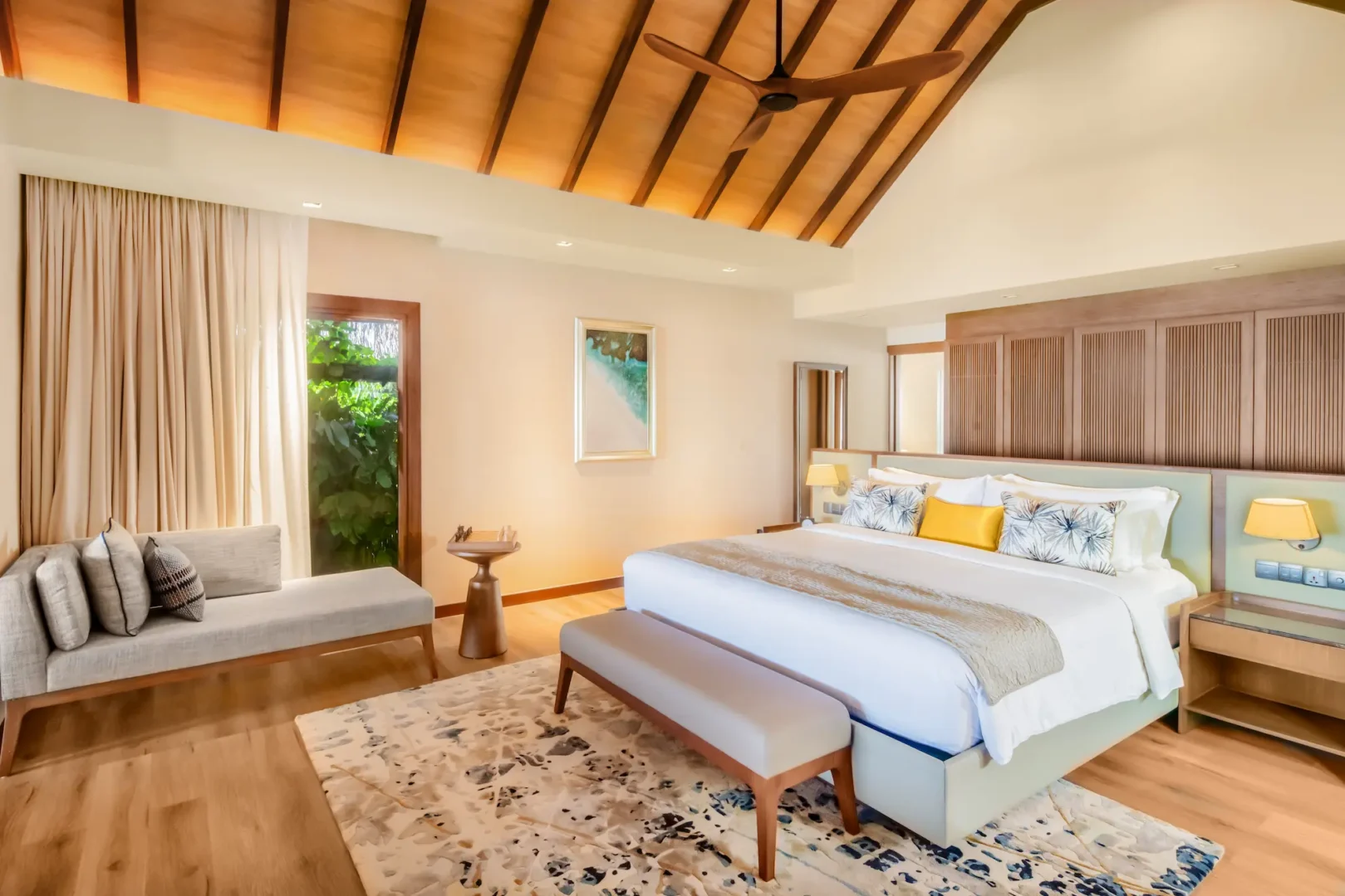 bed area of the baros suite at baros maldives featuring contemporary island design and soft natural tones