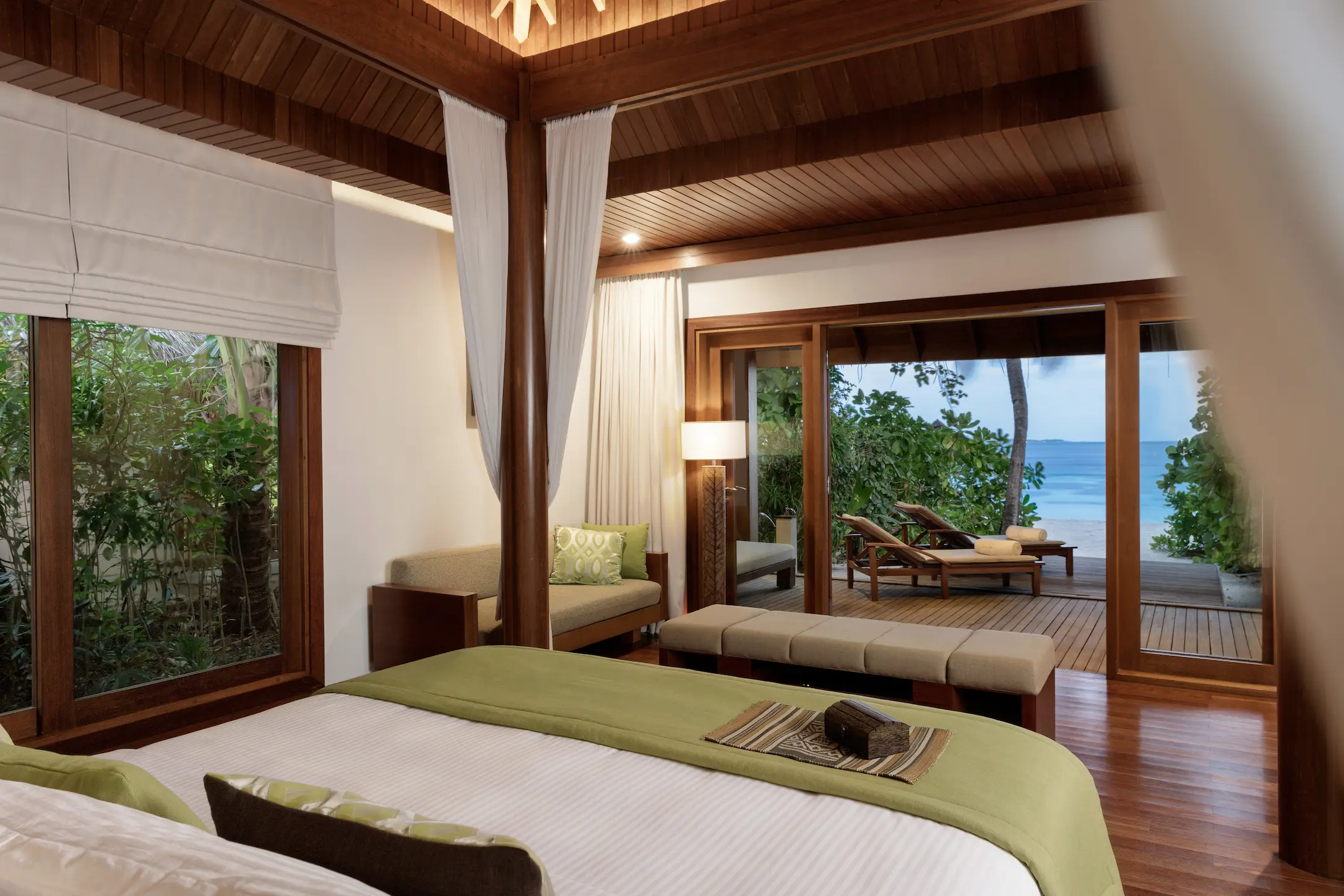 view from the baros villa room at baros maldives overlooking the beach and calm lagoon