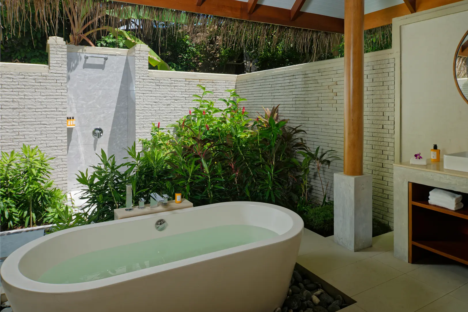 bathroom of the deluxe villa at baros maldives with elegant island design and calming natural light