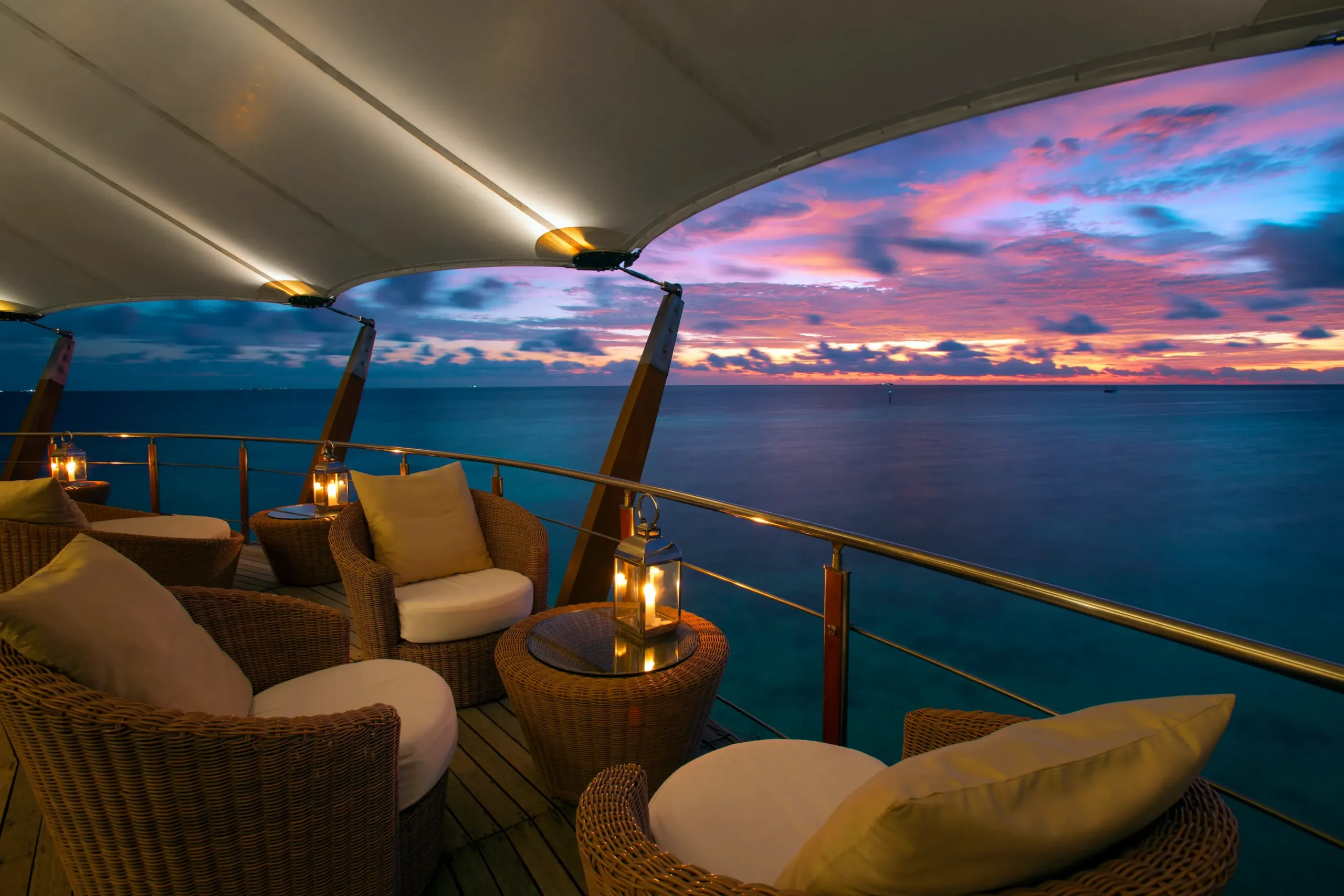 the lighthouse lounge at baros maldives offering elevated overwater seating with serene lagoon views
