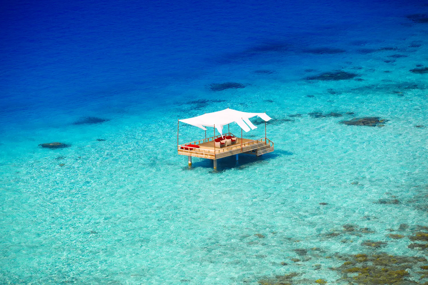 piano deck dining at baros maldives set above the lagoon for an intimate overwater experience