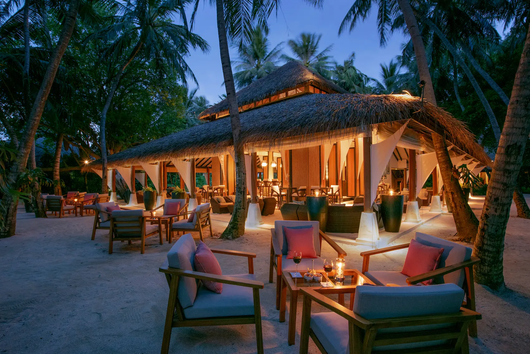 sails bar at baros maldives offering relaxed island drinks beneath palm shaded seating