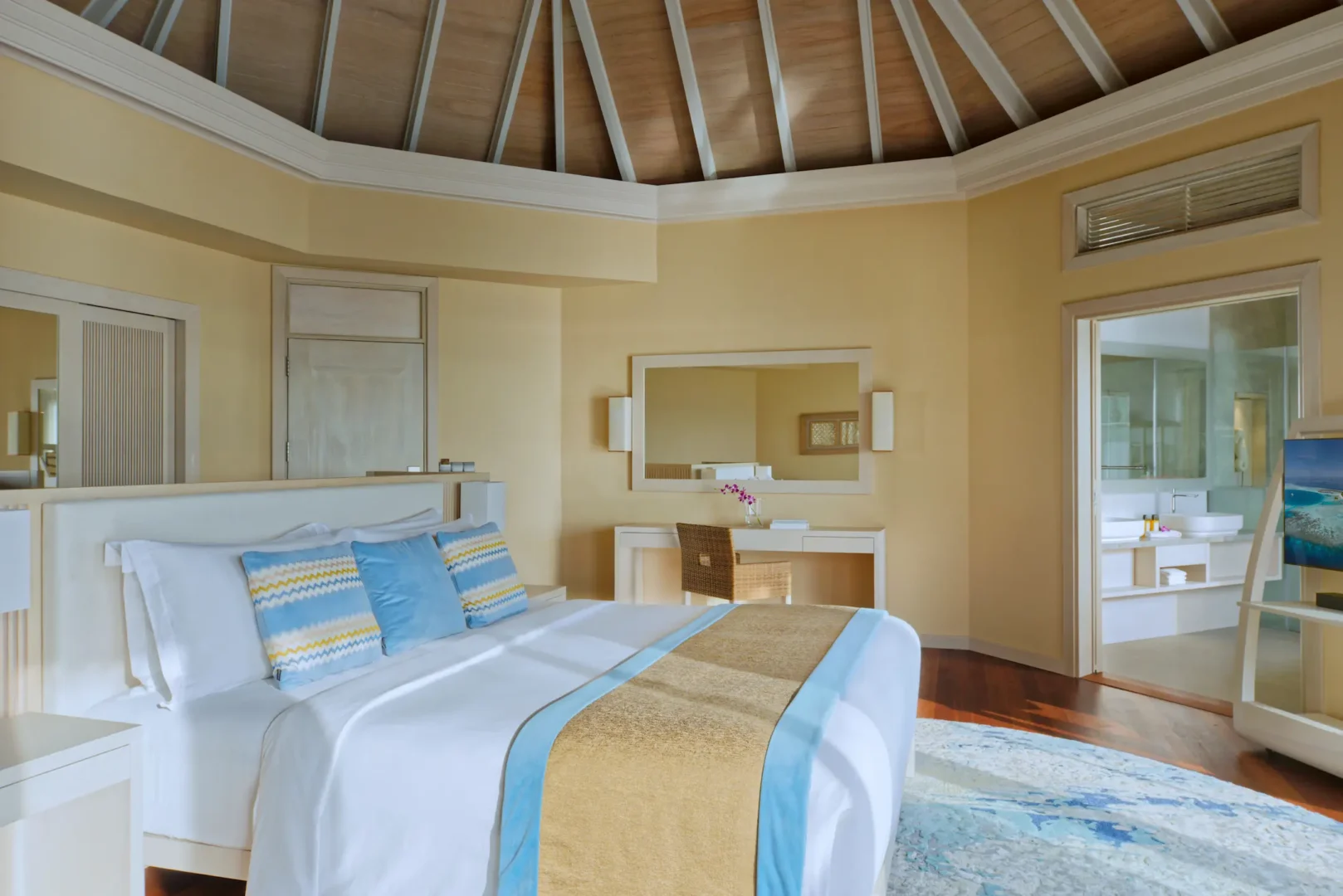 interior of the water pool villa at baros maldives with elegant island design and warm natural textures