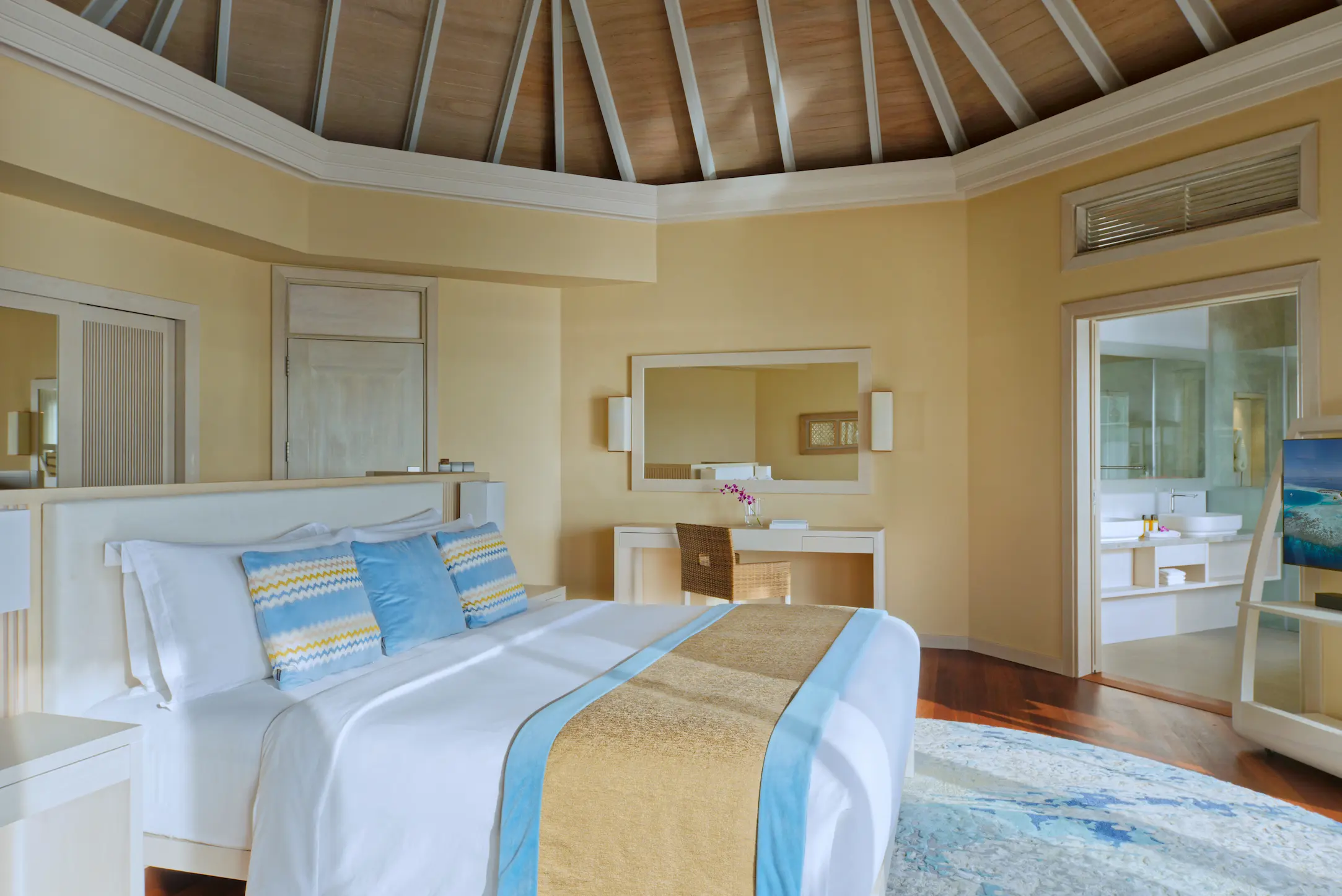 interior of the water pool villa at baros maldives with elegant island design and warm natural textures