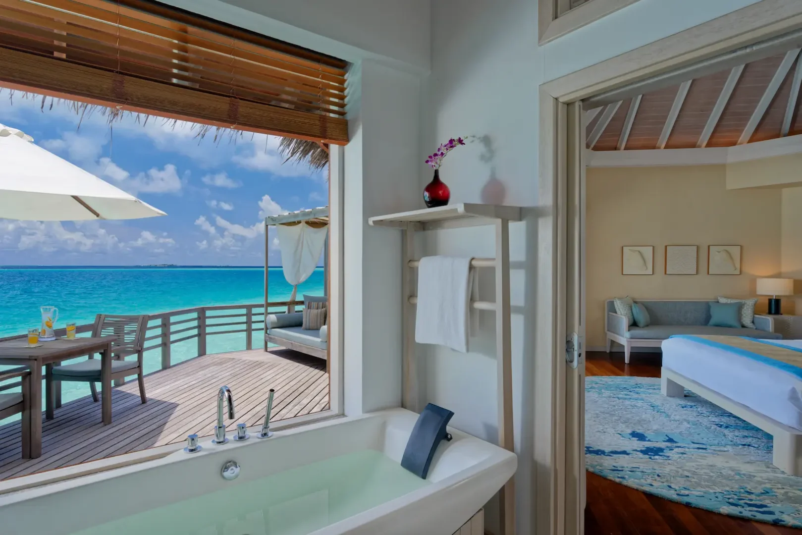 bathroom of the water villa at baros maldives with elegant island design and soft natural light