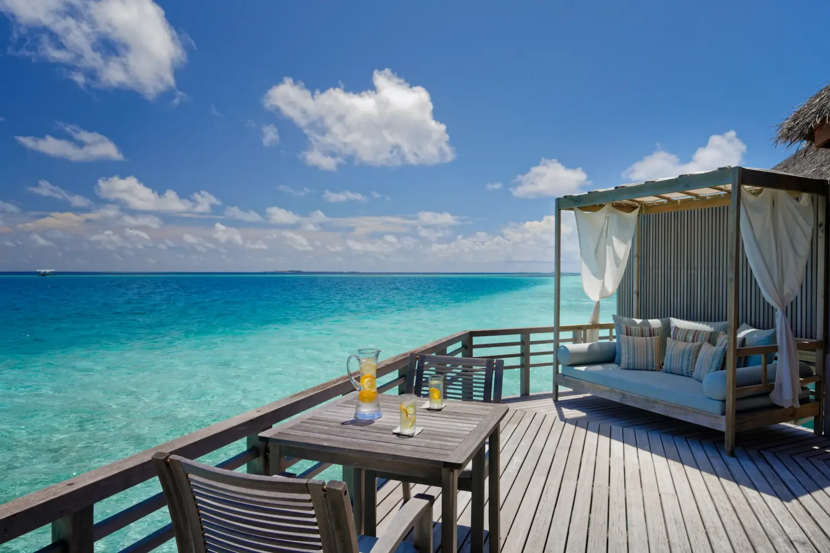 terrace of the water villa at baros maldives overlooking the clear turquoise lagoon