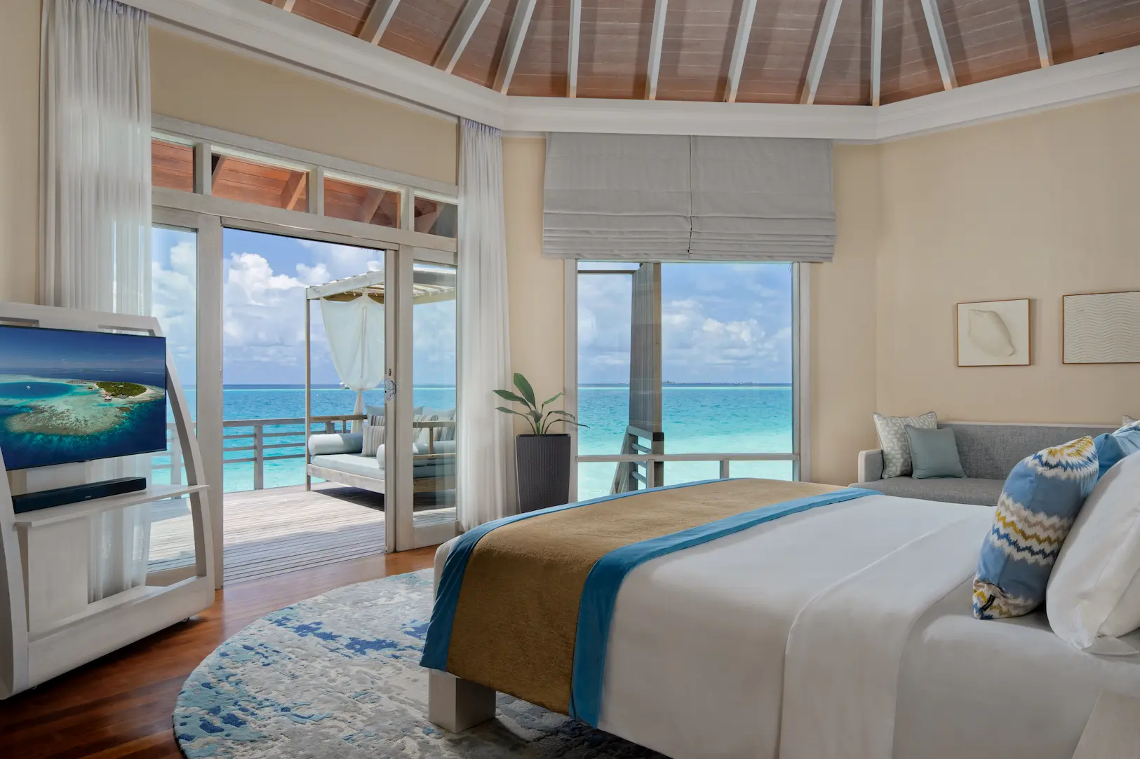 view from the water villa at baros maldives overlooking the clear turquoise lagoon