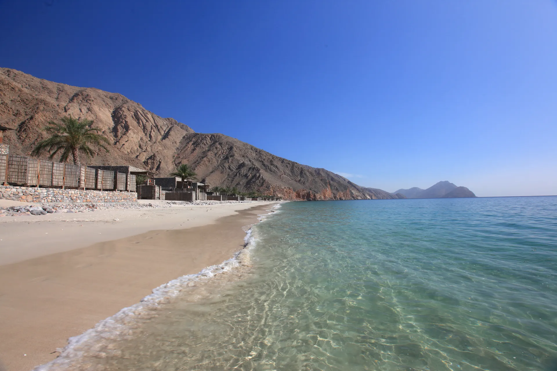 sandy beach and clear sea at six senses zighy bay oman resort