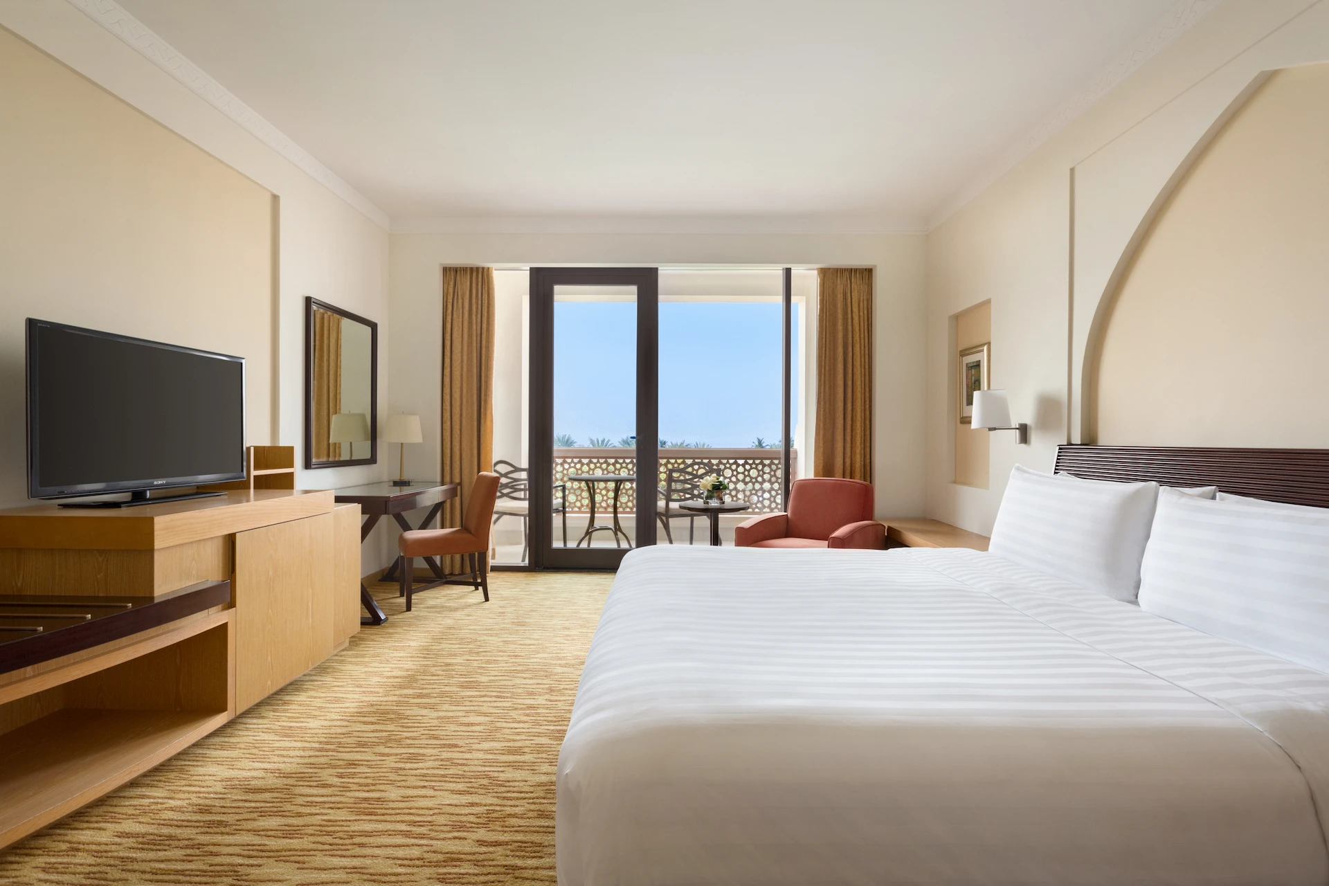 bedroom and balcony in guest room with sea view at hilton muscat al bandar oman