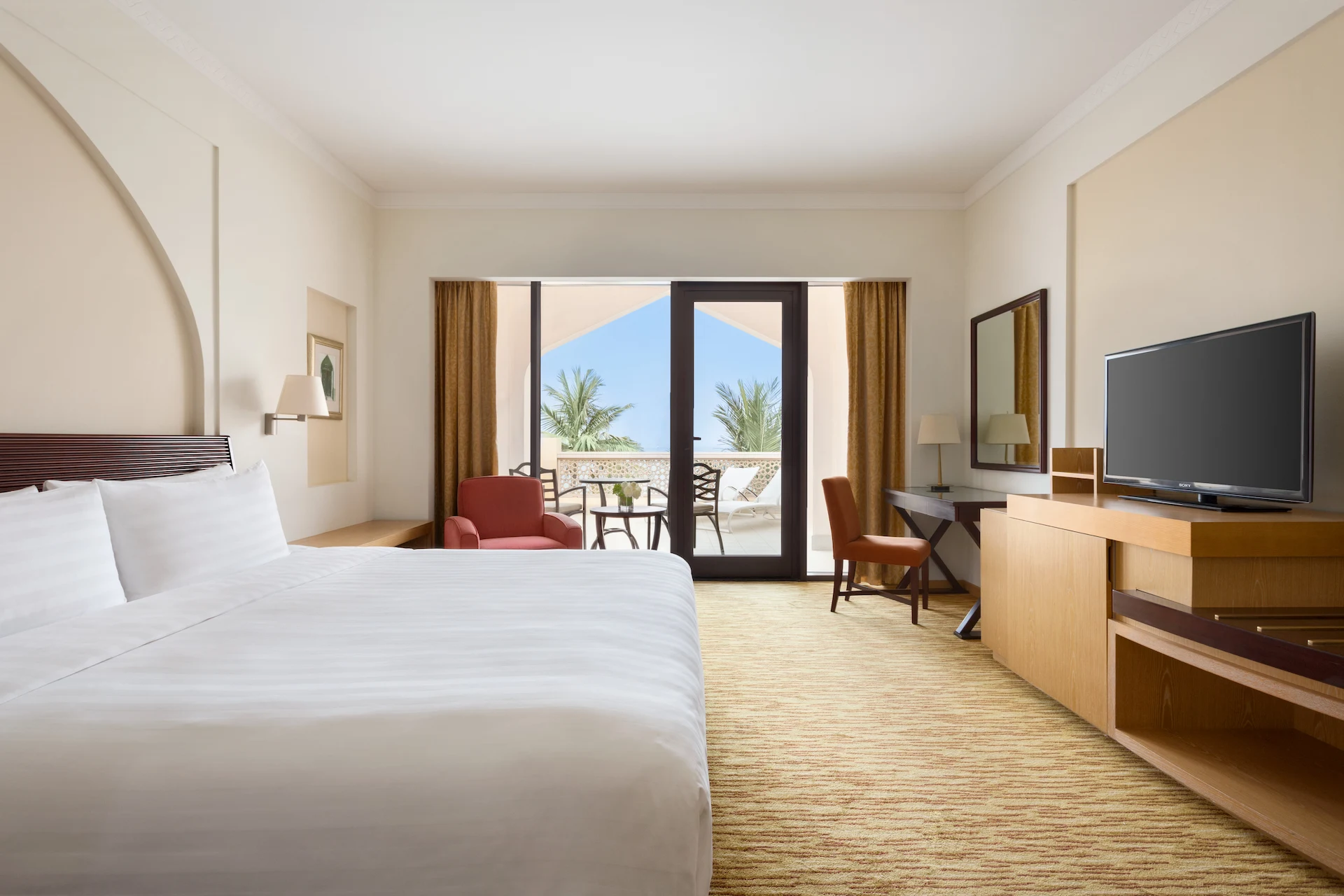 guest room bedroom with sea view at hilton muscat al bandar oman resort