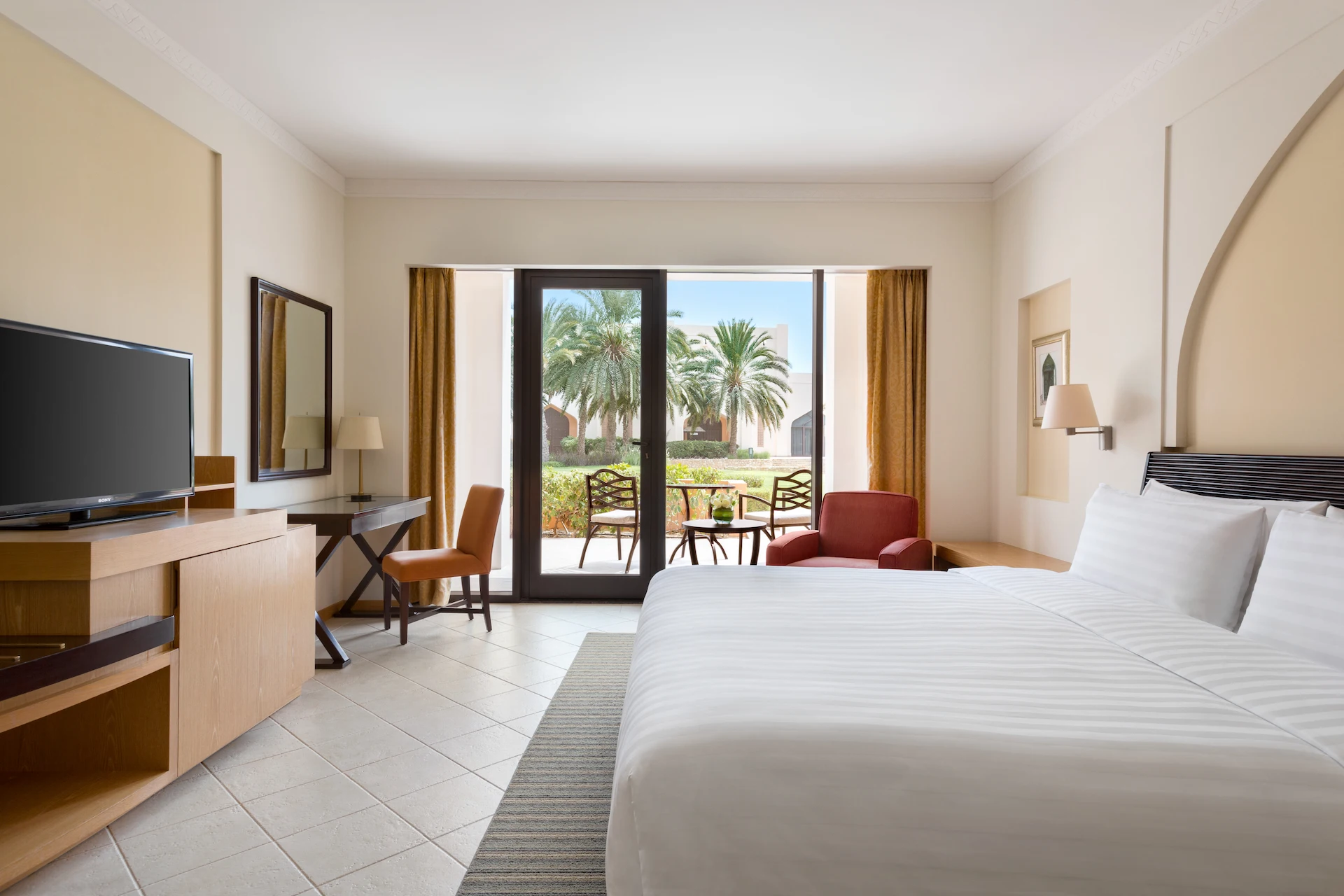 guest room bedroom with terrace at hilton muscat al bandar oman resort