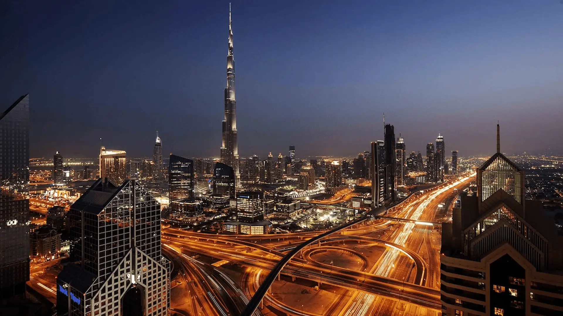 Burj Khalifa towering above the Dubai skyline with a clear sky and surrounding cityscape below