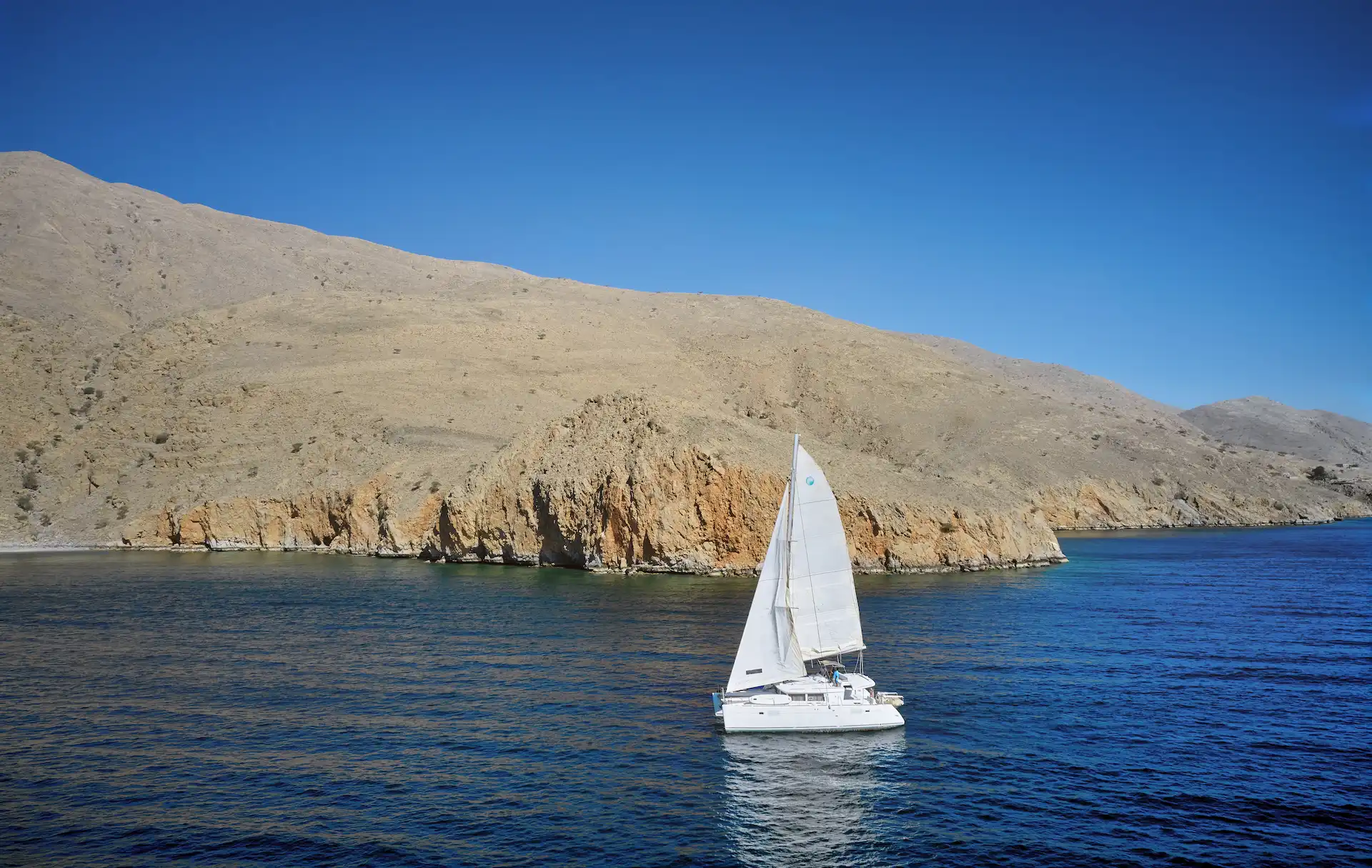 guests on a catamaran cruise at six senses zighy bay oman resort