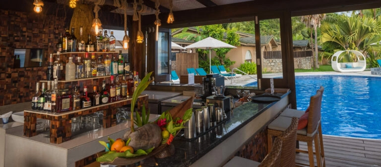 coco de mer seychelles mango terrace with outdoor seating, panoramic ocean views, and tropical garden surroundings