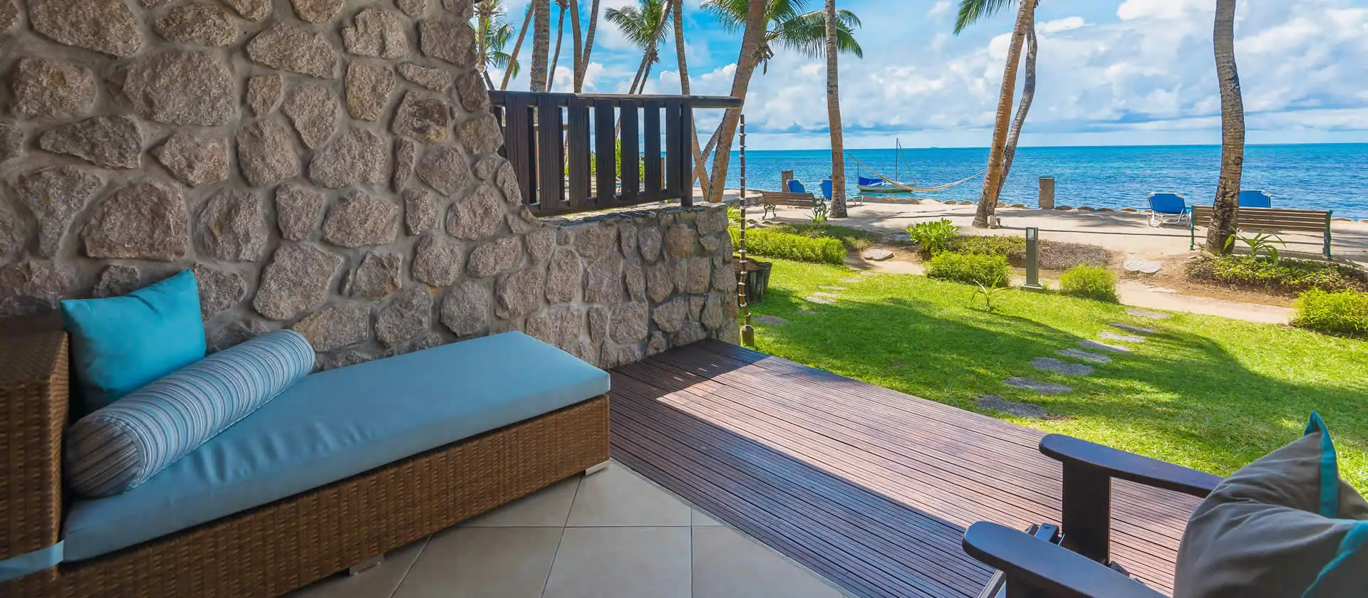 coco de mer seychelles superior room terrace with seating area, ocean or garden views, and tropical surroundings