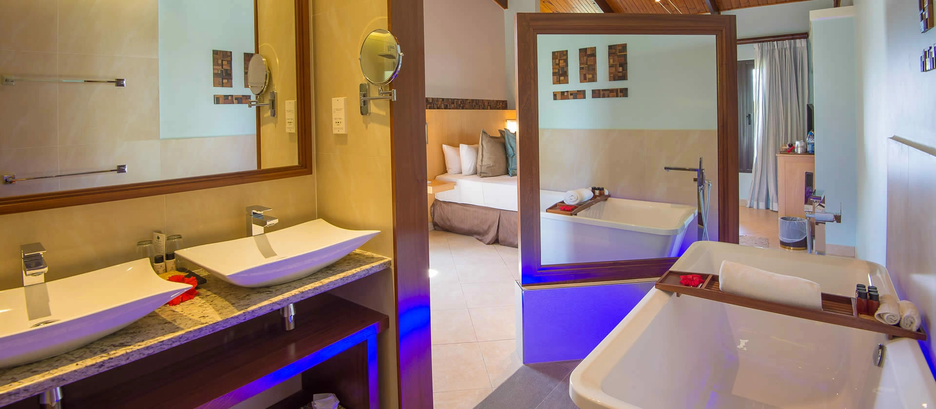 coco de mer seychelles standard room bathroom with modern fixtures, spacious layout, and tropical garden or ocean views