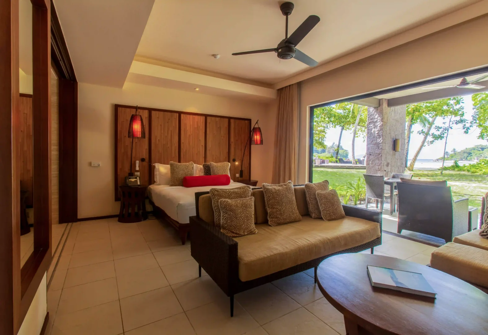 constance ephelia junior suite room with bedroom living area and tropical decor
